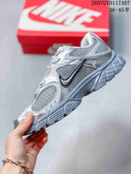 Side view highlighting the contrasting Swoosh-style branding, layered panels, and thick outsole.