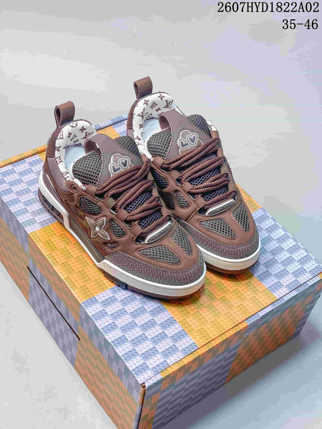 Pair of brown Trainer-style sneakers with dark mesh panels and patterned collar lining.