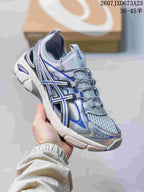 Angled side view of the silver and blue ASICS Gel-Kayano 14 sneaker showing its layered upper and sculpted sole.