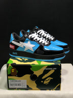 Black, blue, and white BAPE STA sneakers displayed on a camouflage BAPE shoe box; the box label shows a sample size of US 8, UK 7, EU 41, and CM 26.