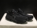 Three-quarter front view of the black lace-up sneakers with textured uppers and sculpted outsoles.