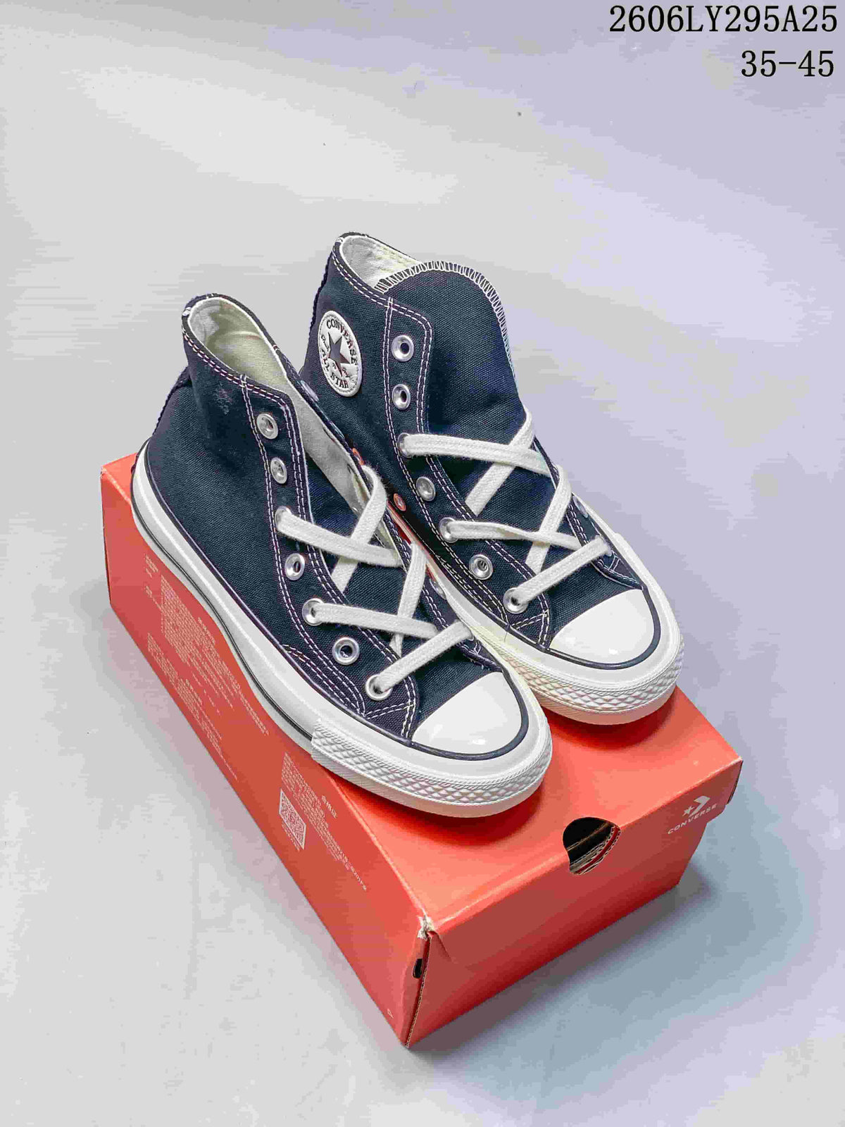 Pair of navy Converse Chuck Taylor All Star 19 high-top sneakers displayed on a red shoe box; style code 2606LY295A25 and size range 35–45 are visible.