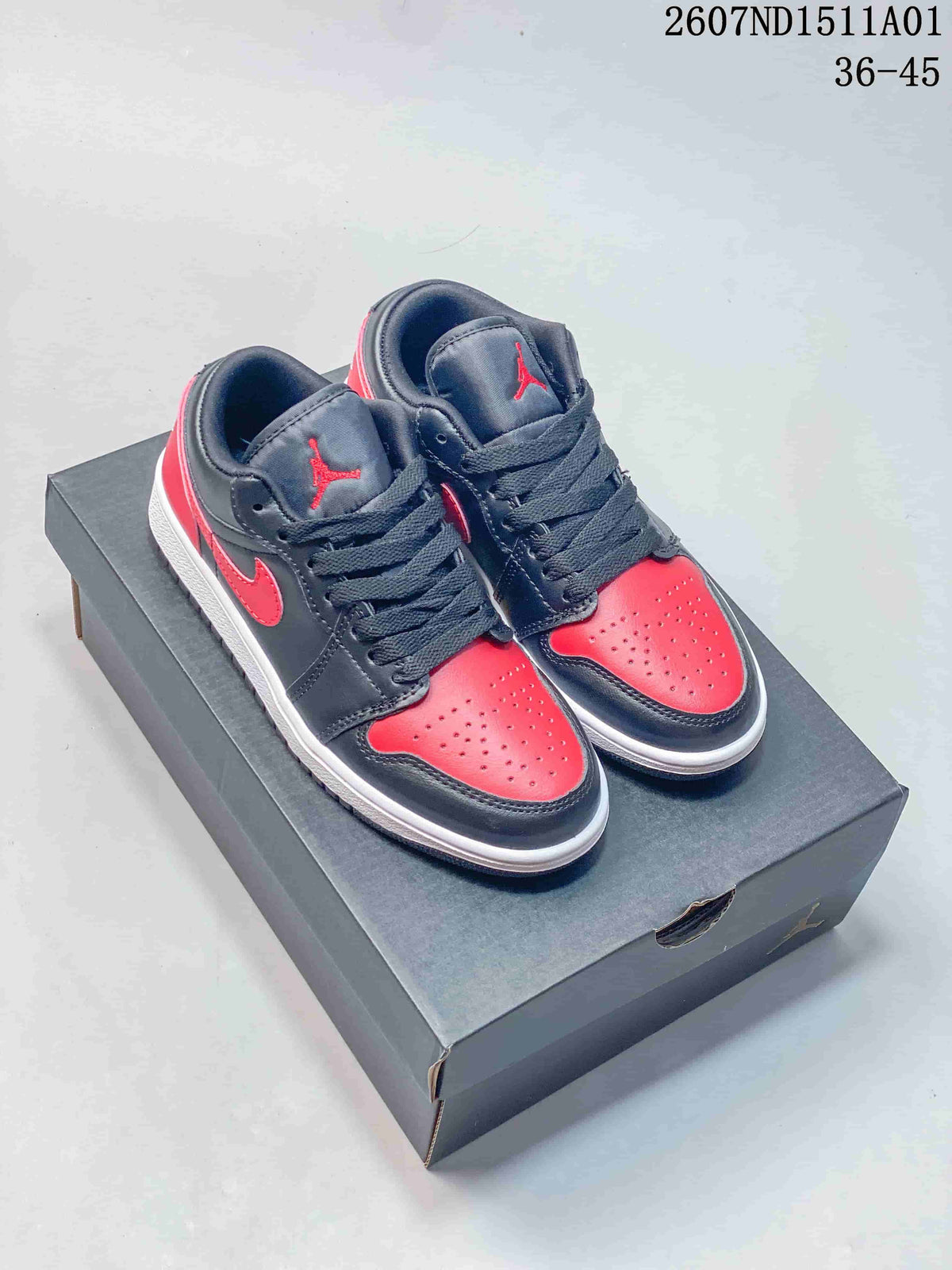 Pair of black and red low-top Jordan sneakers shown on a shoe box