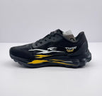 Opposite side view of the black sneaker showing the white and yellow graphic treatment and heel branding.