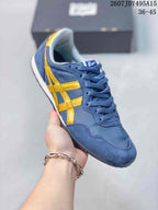 Angled close view of the blue and yellow sneaker showing its lace-up construction, contrasting side stripes, white midsole, and dark outsole; image text shows size range 36-45.