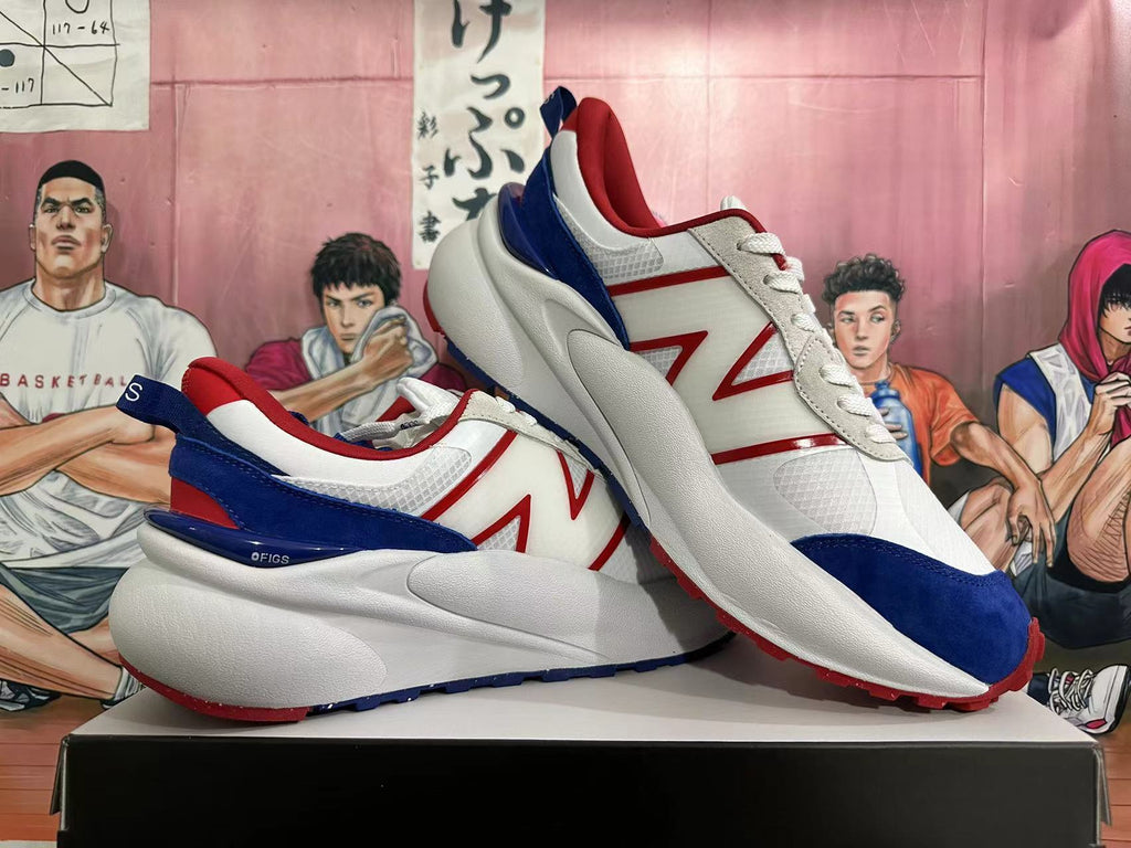 Pair of white New Balance sneakers with red and navy accents, shown from the side.