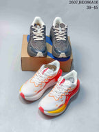 Two ASICS colorways shown together: gray and navy, plus white with red, orange, and yellow accents.