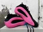 Pair of black and pink sneakers displayed in overlapping side views.