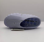 Top-down view of a purple slide showing Nike branding on the footbed and perforated strap.
