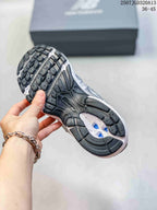 Close view of the sneaker outsole showing a black-and-white treaded rubber sole.