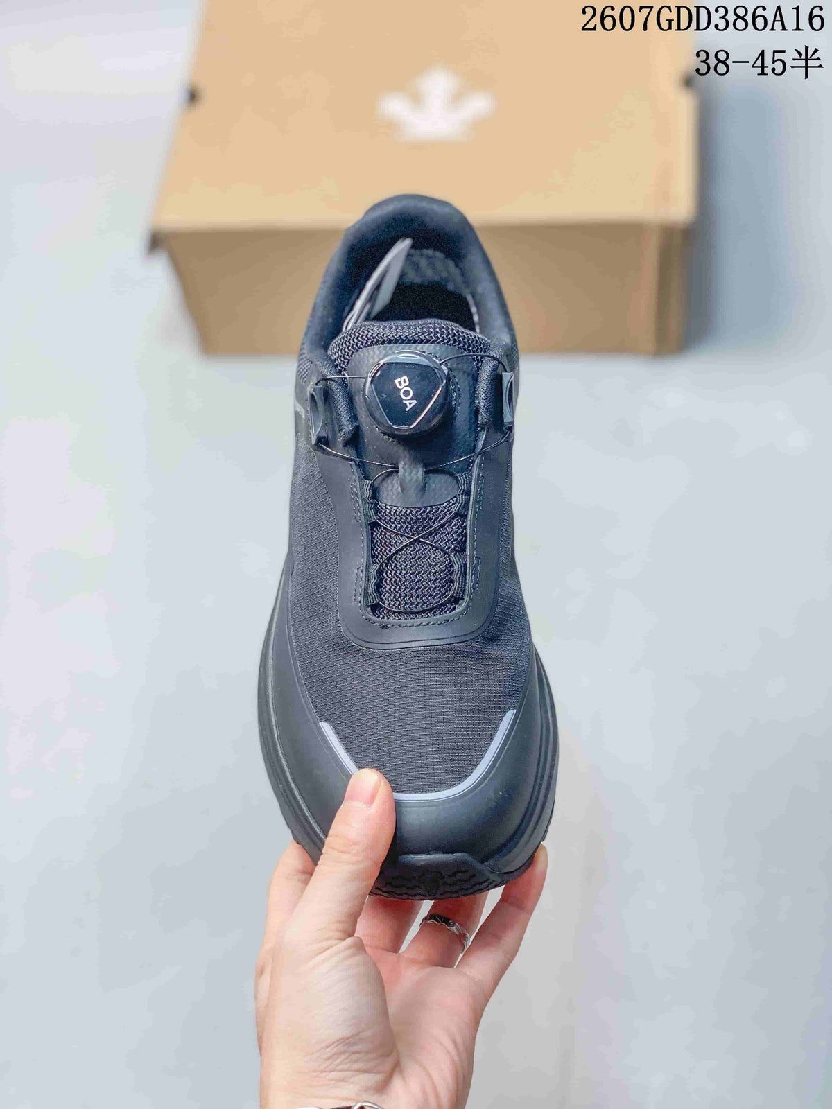 Top view of the black sneaker showing the textured upper, BOA-style dial, and rounded toe design.
