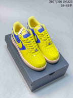 Pair of yellow and blue Nike Air Force 1 '07 low-top sneakers displayed on a shoebox.