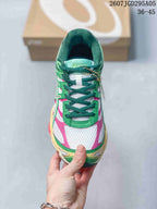 Top view showing the green laces, white mesh-style toe area, pink accents and padded collar.