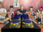 Front view of blue and yellow Nike basketball sneakers showing yellow tongue emblems and graphic forefoot detailing.