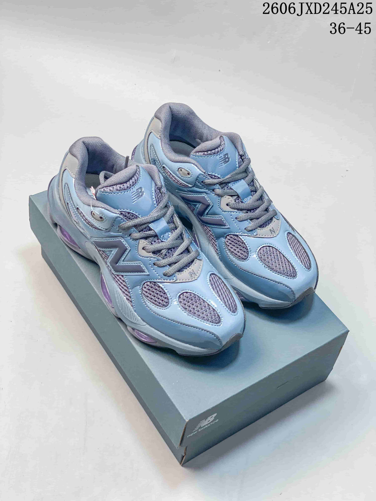 Blue and gray New Balance 9060 sneakers with purple accents, shown on a shoebox