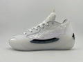 Side view of a white lace-up sneaker with a textured upper, layered side detail, and sculpted sole