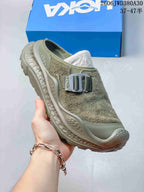 Angled view of the olive-toned mule sneaker with buckle detail and sculpted sole