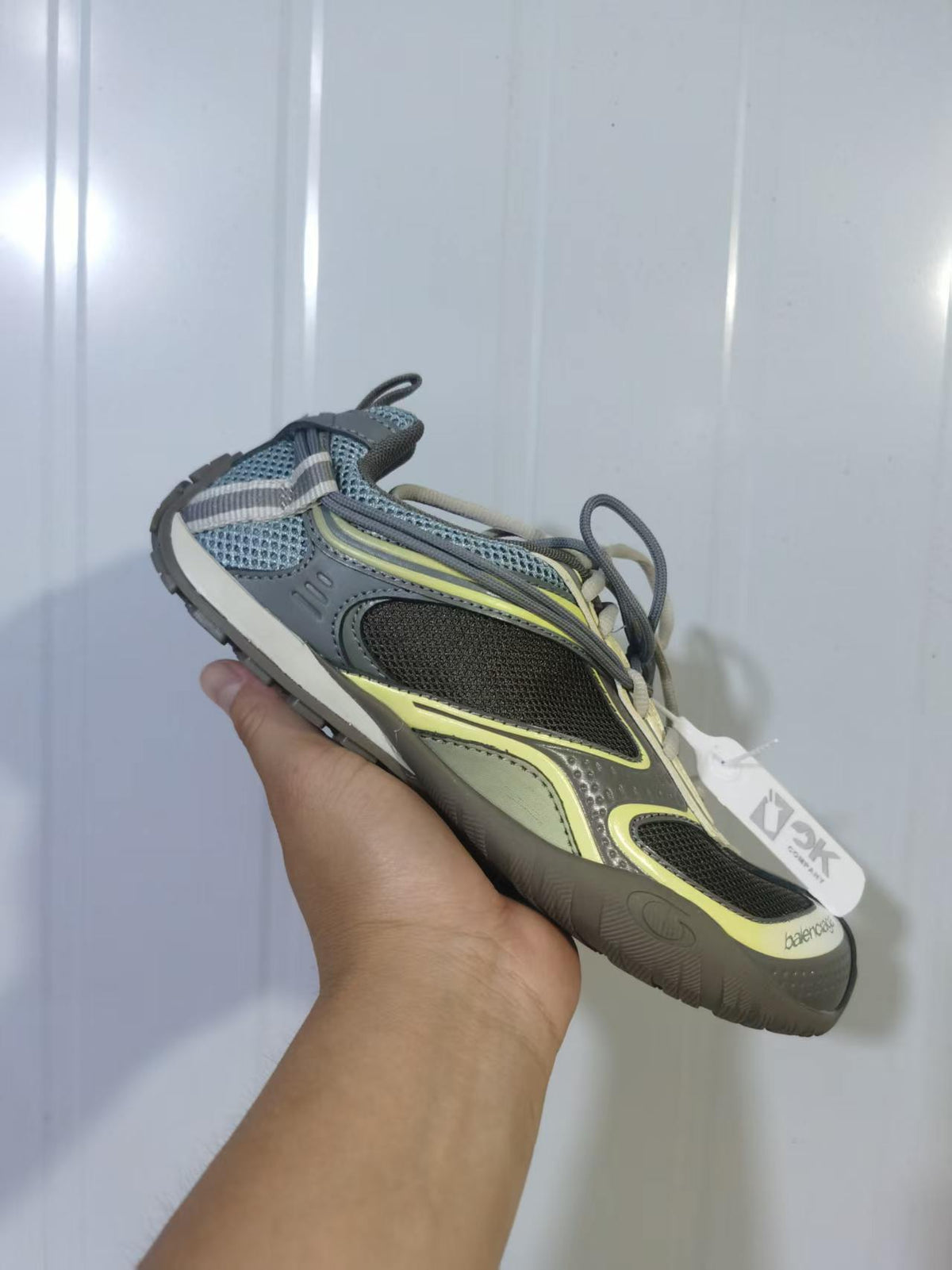 Close-up side view of a Balenciaga Radar sneaker in khaki, yellow, gray, black, and cream tones.