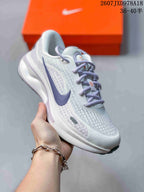 Angled side view of the Nike Journey Run sneaker showing the patterned upper, lavender Swoosh, laces and layered sole.