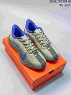 Gray Nike Pegasus Plus Next Nature shoes with blue accents on an orange shoebox
