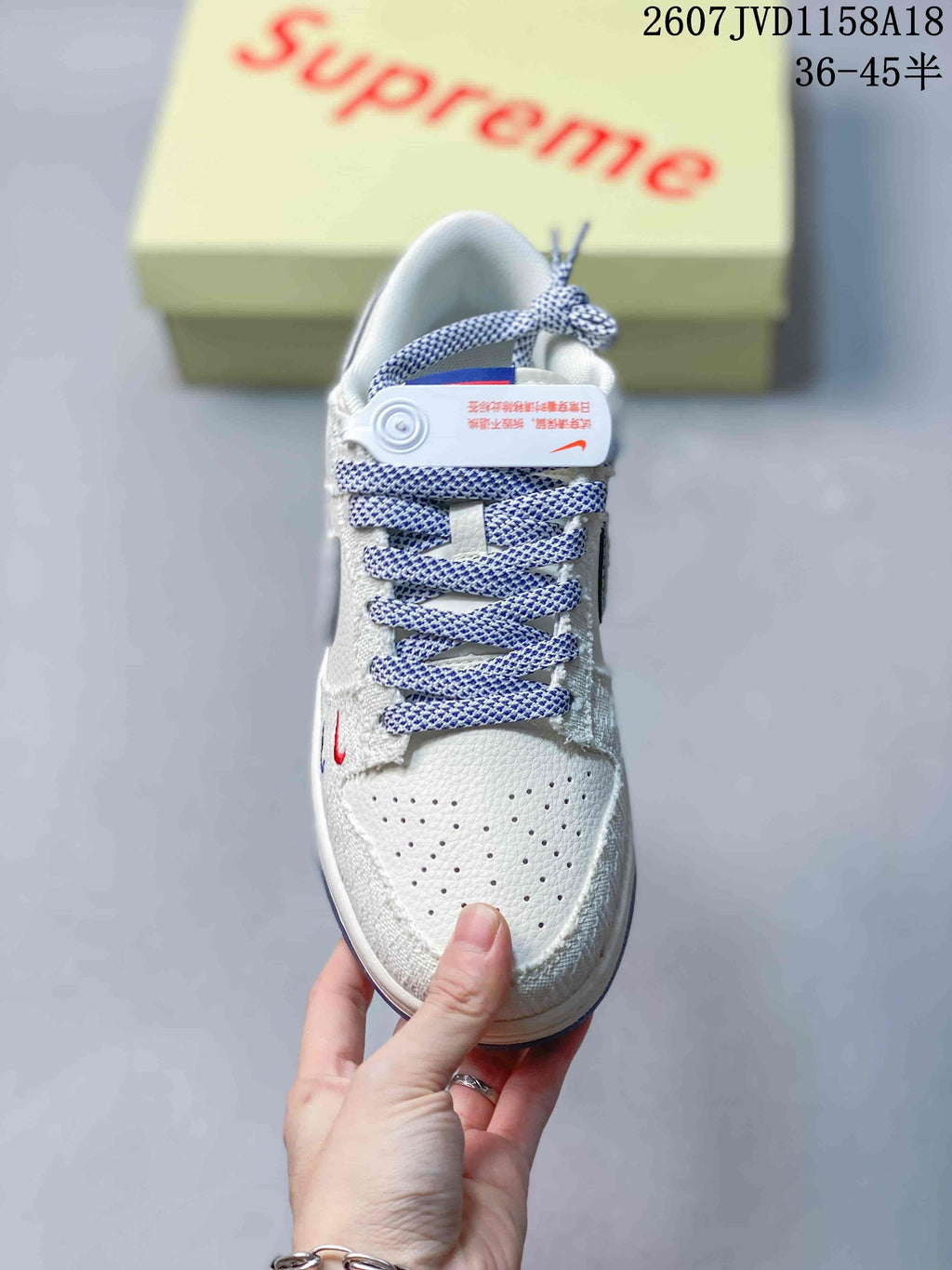 Top view showing the perforated toe box, patterned laces, and small red and blue embroidered details.