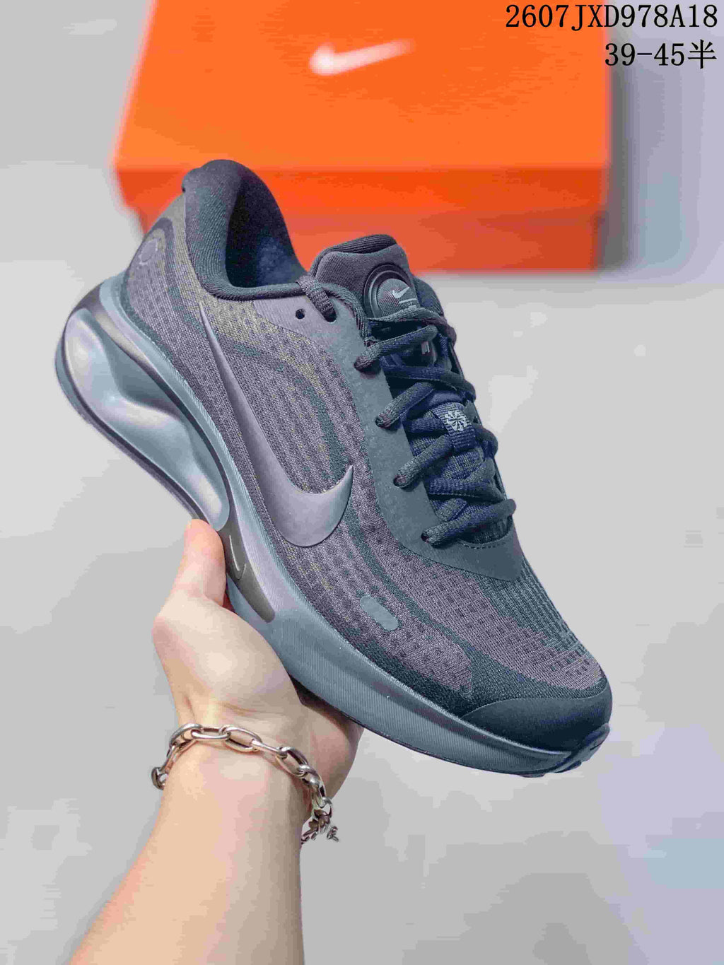 Dark gray Nike Journey Run sneaker with a tonal patterned upper and matching cushioned sole.