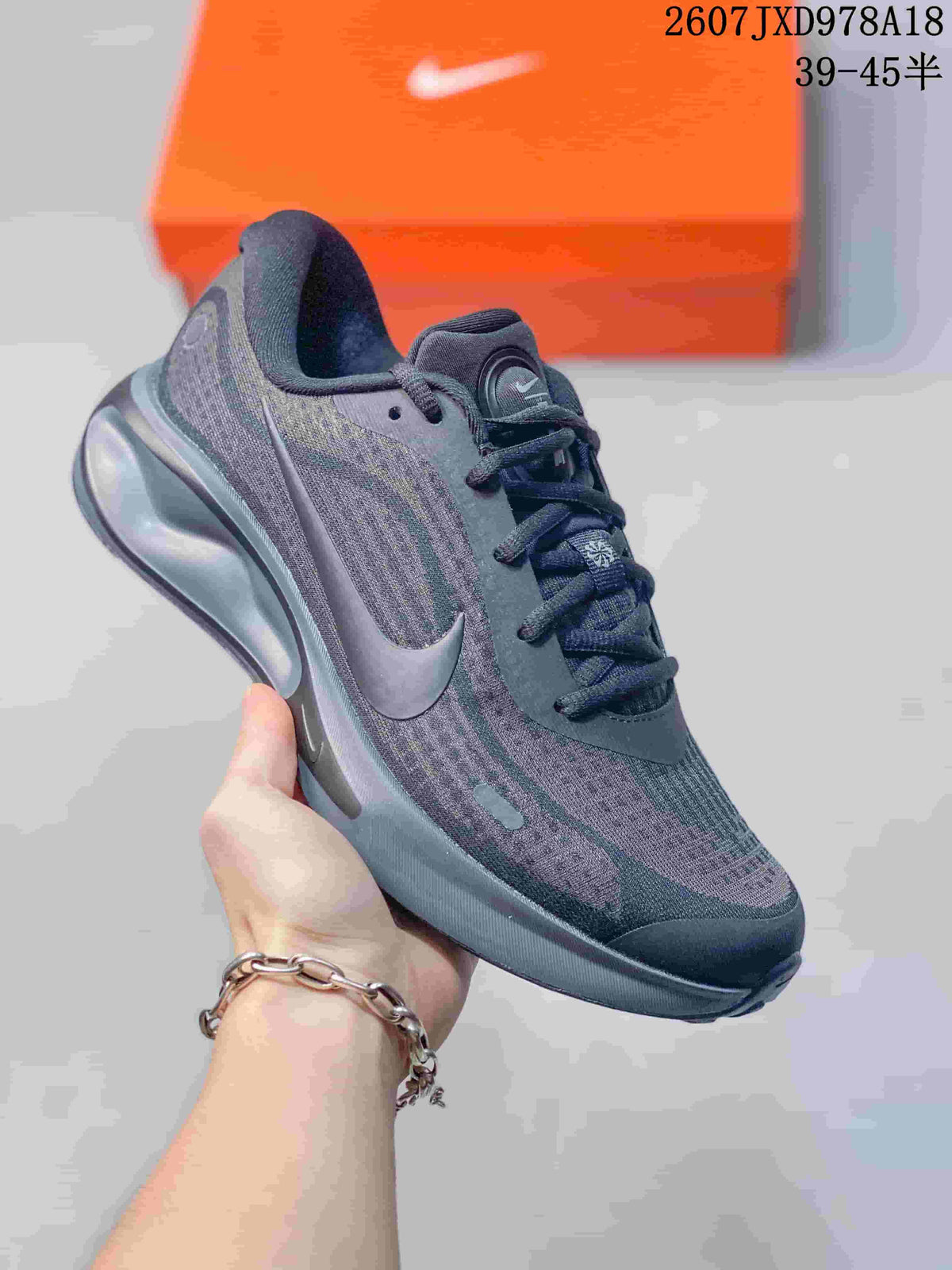 Dark gray Nike Journey Run sneaker with a tonal patterned upper and matching cushioned sole.