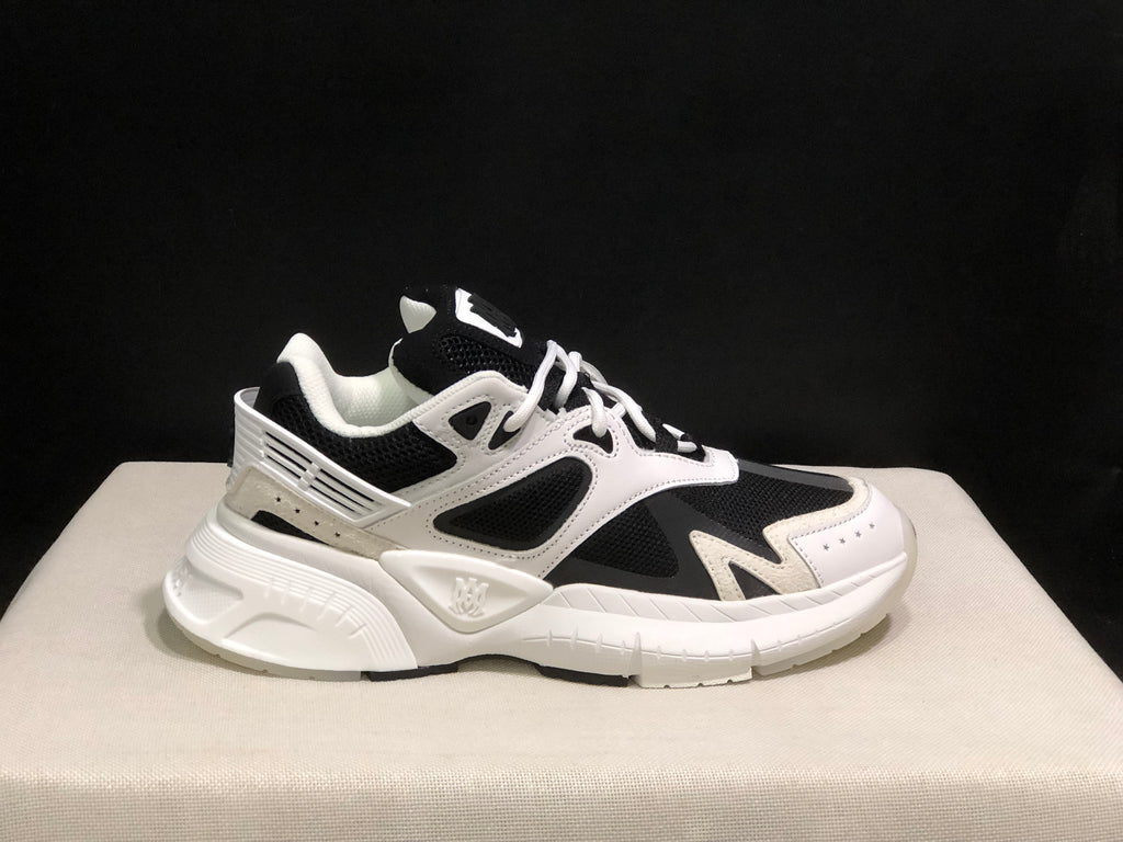 Single side profile of the white and black AMIRI MA Runner sneaker with visible branding.