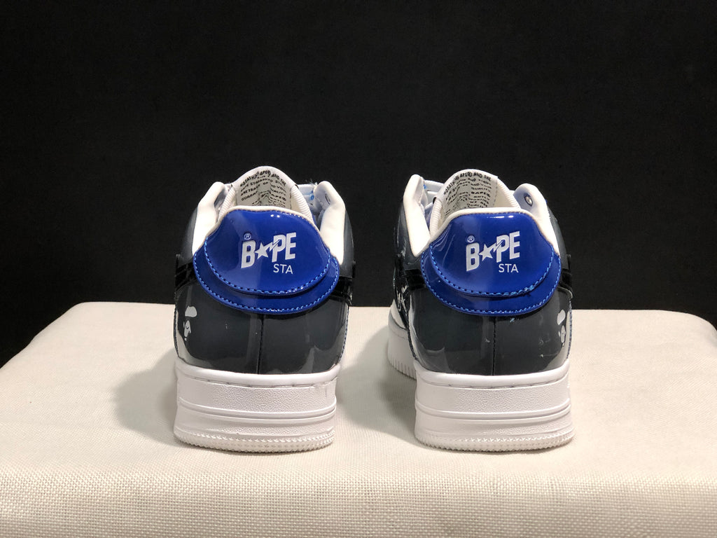 Rear view of the blue and gray Bape Sta sneakers showing blue heel panels, white collars, and branded heel tabs.