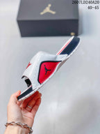 Side view of a white Jordan slide with red and black panels, adjustable strap, and patterned outsole; image text shows style code 2607LD240A20 and sizes 40–45.