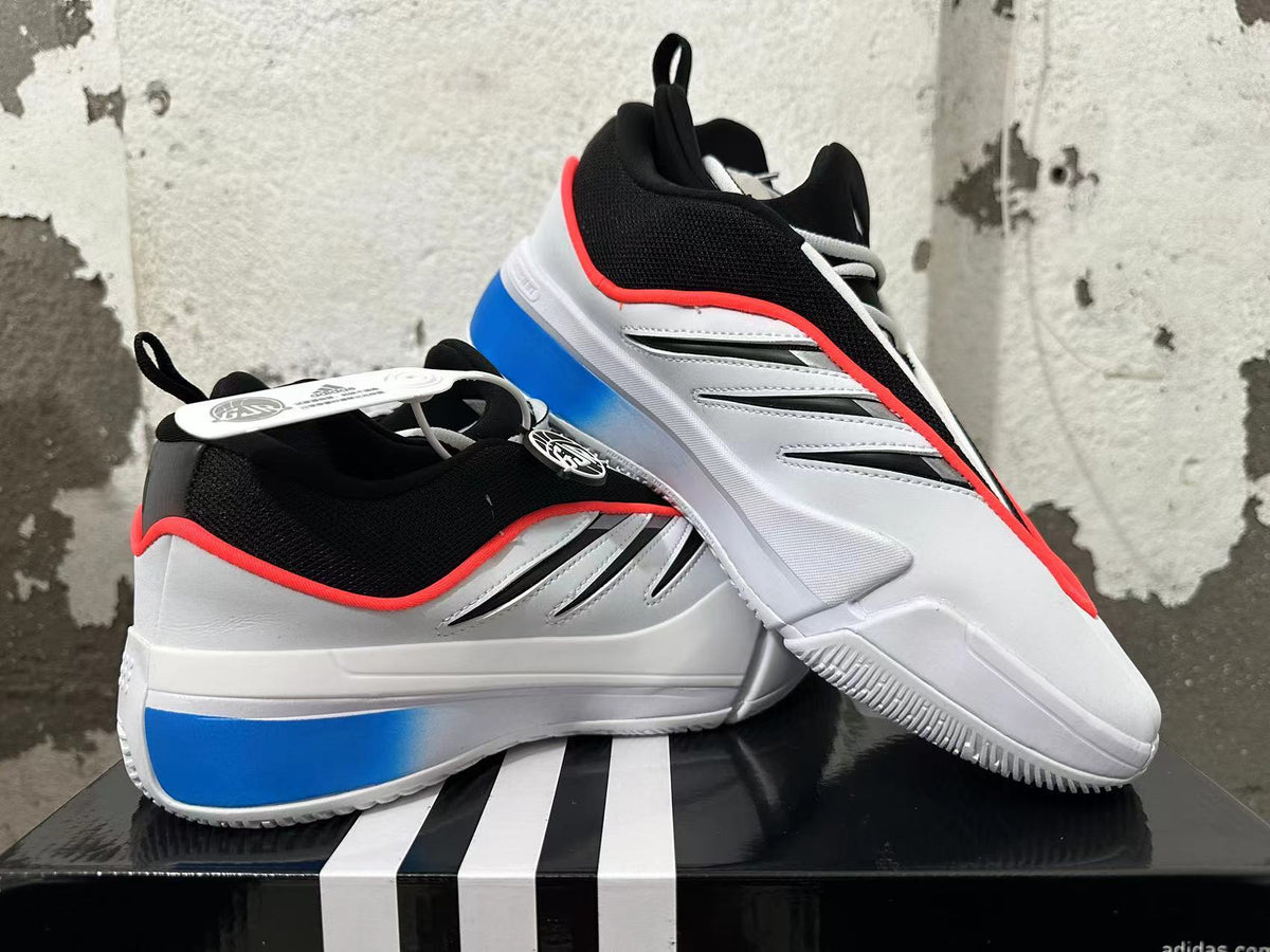 Pair of white, blue, and black basketball shoes shown from the side