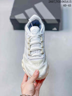 Top view of the white lace-up sneaker showing the padded tongue, woven laces, perforated toe area, and inner lining.