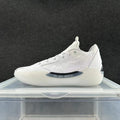 Side view of white Jordan 39 sneakers with patterned panels and a sculpted pale outsole.