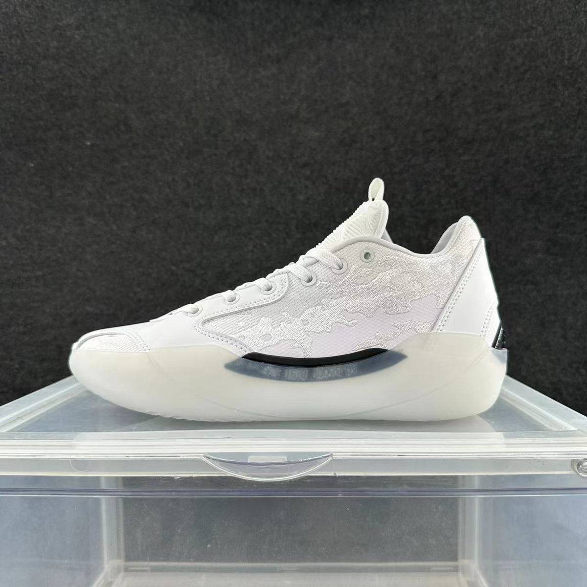 Side view of white Jordan 39 sneakers with patterned panels and a sculpted pale outsole.