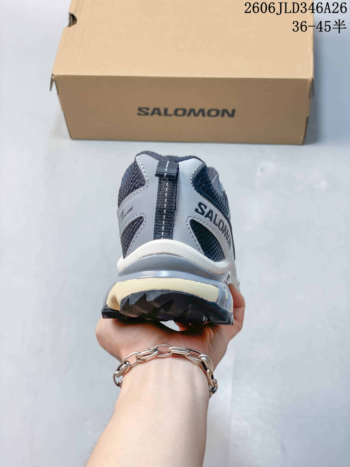 Rear view of a gray Salomon XT-6 sneaker showing the heel pull tab