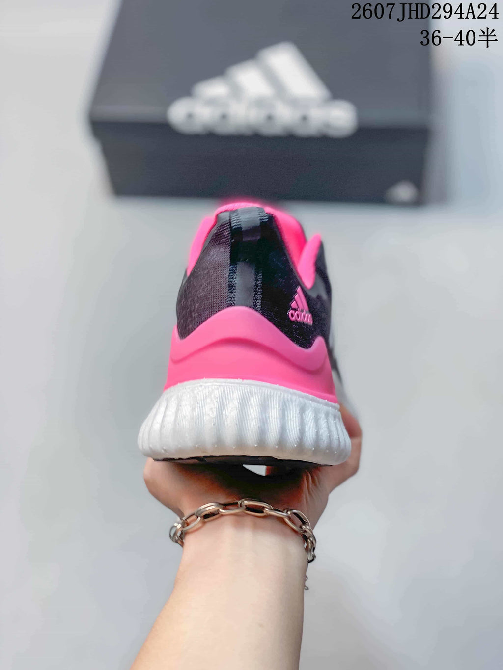 Rear view showing the pink heel panel, white midsole and adidas branding.