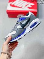 Side view highlighting the gray and white upper, dark Nike Swoosh, blue accents, and heel cushioning unit.