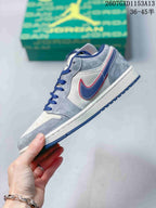 Side profile showing the grey upper, blue-and-red Swoosh, white midsole and blue outsole.