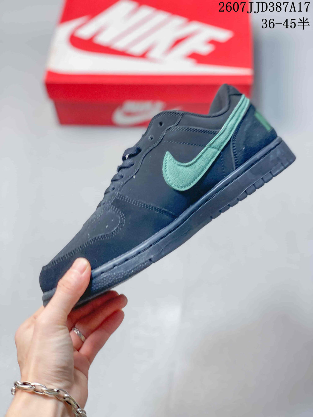 Side profile showing the green Swoosh, black upper, and low-profile rubber sole.