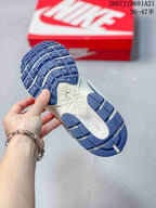 Underside view of a Nike V5 RNR sneaker showing the blue segmented outsole and white central midsole section.