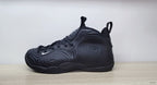 Opposite side profile of a black high-top sneaker with laces and a small white Swoosh.