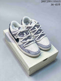 Pair of gray, white, and navy Nike SB Dunk Low sneakers displayed on a shoe box; image text shows style code JDD1155A15 and size range 36–45.