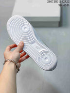 View of the white textured outsole with circular tread patterns and Nike branding.