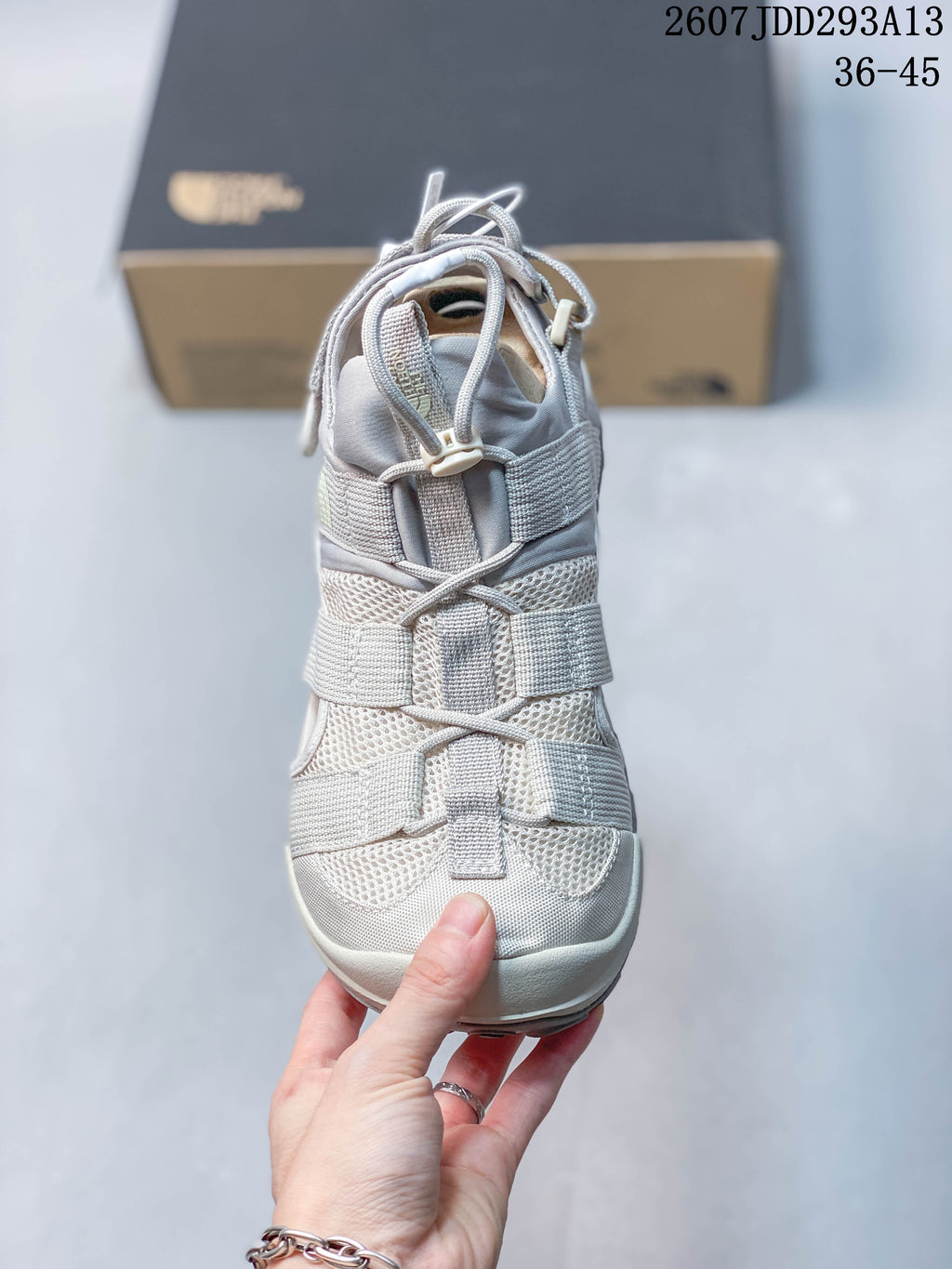 Top view of the sandal showing the layered strap layout, lace-and-toggle fastening, and mesh upper panels.