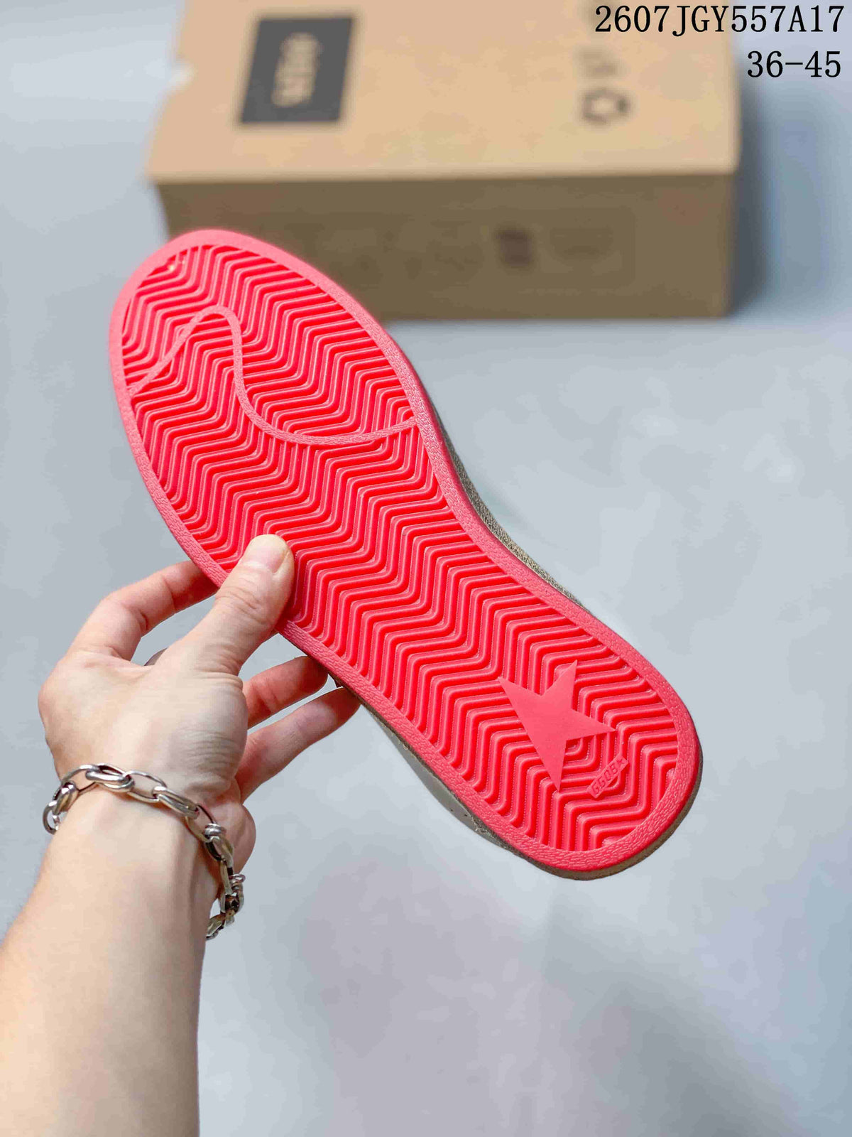 Close view of the red outsole showing its textured herringbone-style tread and embossed star detail.