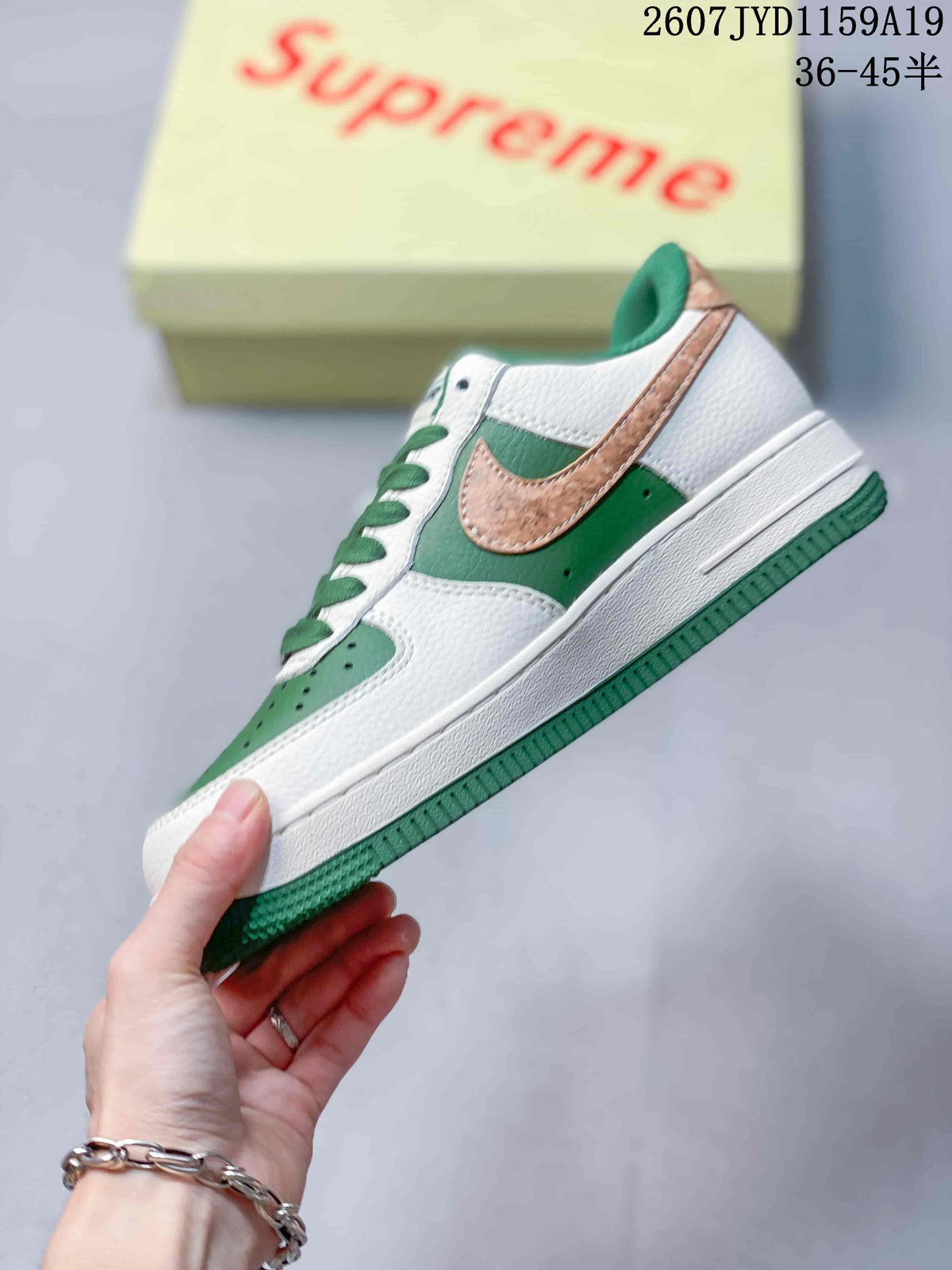Side profile showing the white upper, green quarter panel, tan Swoosh and green outsole.