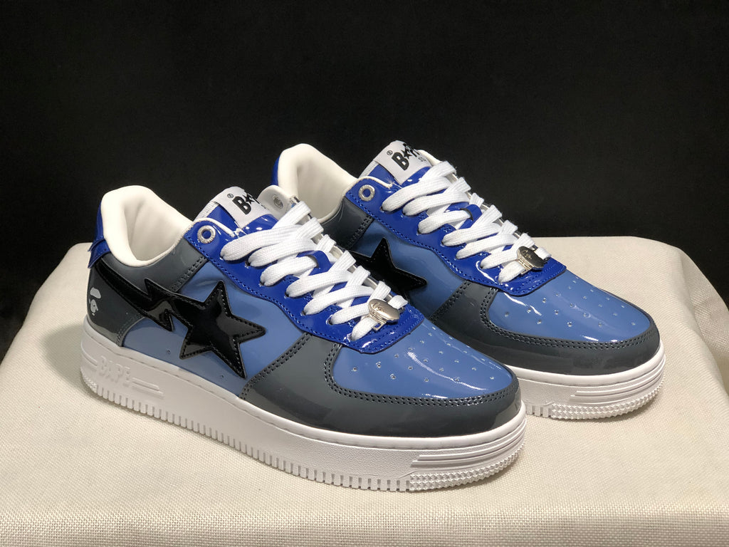 Three-quarter view of the pair highlighting the blue and gray panels, black star details, and white midsoles.