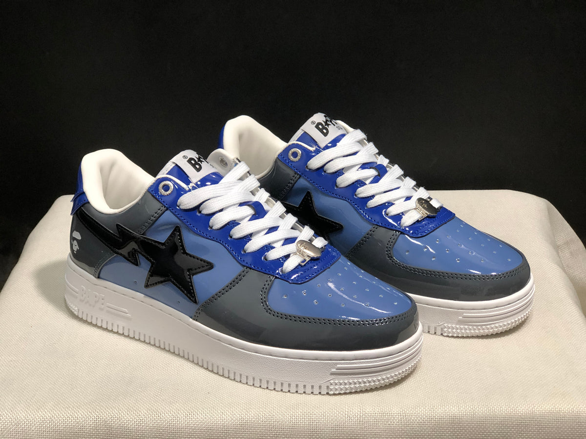 Three-quarter view of the pair highlighting the blue and gray panels, black star details, and white midsoles.