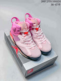 Pair of pink high-top Nike Air Jordan 6 sneakers displayed on a shoebox, showing white laces, red accents and black outsole details.