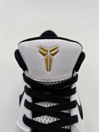 Front view of the tongue with gold Kobe emblem and black laces